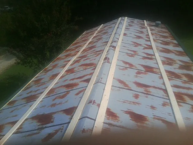 Rusted metal roof panels with new wood purlins before replacement — Storm Damage Roof Repair in Adah by Roofing Brothers