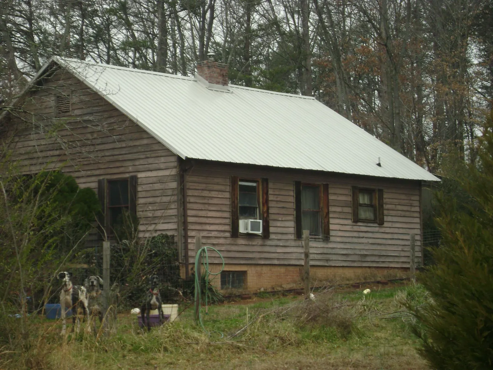 White metal roof on an old wood sided farmhouse, from a Metal Roof Installation job in Adah